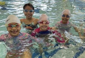 young kids in summer camp at the pool